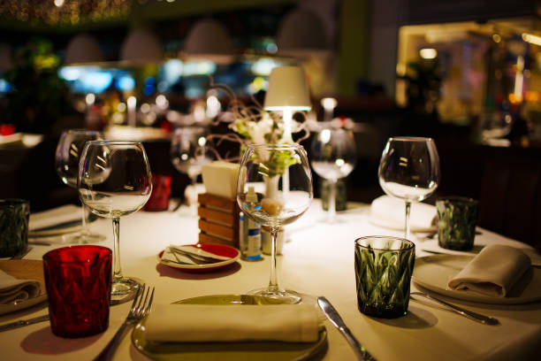 istock a table with a white tablecloth, glasses, crockery and decor in dark restaurant 1465744424