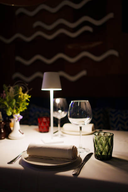 istock a table with a white tablecloth, glasses, crockery and decor in dark restaurant 1465744959