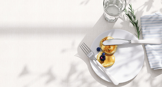 Top view, dining table, soft tablecloth with space, pancake, blueberry in white ceramic plate, knife, fork, blue stripe napkin and glass of water in sunlight, leaf shadow for food, drink background 3D