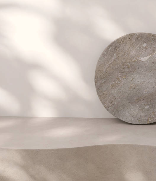 istock Blank beige brown cement curve counter podium with texture, soft dappled sunlight, leaf shadow on white wall, gray flat round rock 1465749926