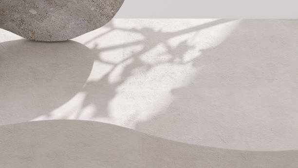 istock Blank white curve concrete counter podium with texture, soft sunlight, leaf shadow on wall, gray flat round rock 1465749929