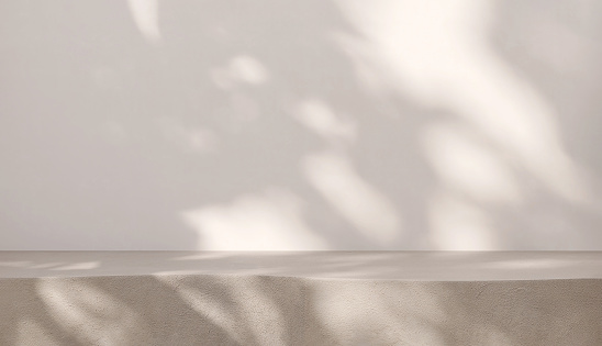 Blank beige brown cement curve counter podium with texture, soft beautiful dappled sunlight, leaf shadow on white wall