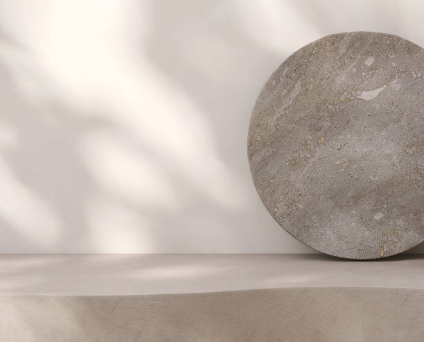 istock Blank beige brown cement curve counter podium with texture, soft dappled sunlight, leaf shadow on white wall, gray flat round rock 1465749946