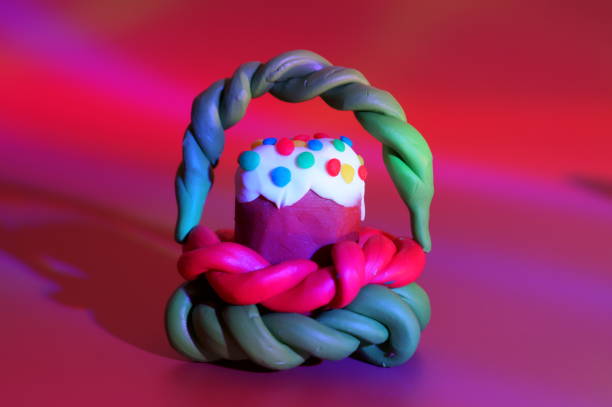 istock A toy Easter cake with a basket on a red background. 1465753292
