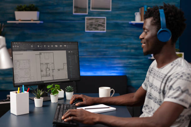 istock Real estate technician sitting at desk in front of computer 1465757252