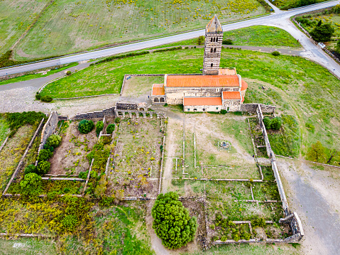 Aerial view of the Romanesque Basilica of the Santissima Trinità of Saccargia, a church in Pisan Romanesque style located in the province of Sassari, dating back to the 12th-century