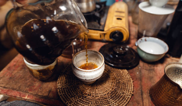 istock Man pouring hot water on ground coffee with paper filter to making a drip coffee 1465758539