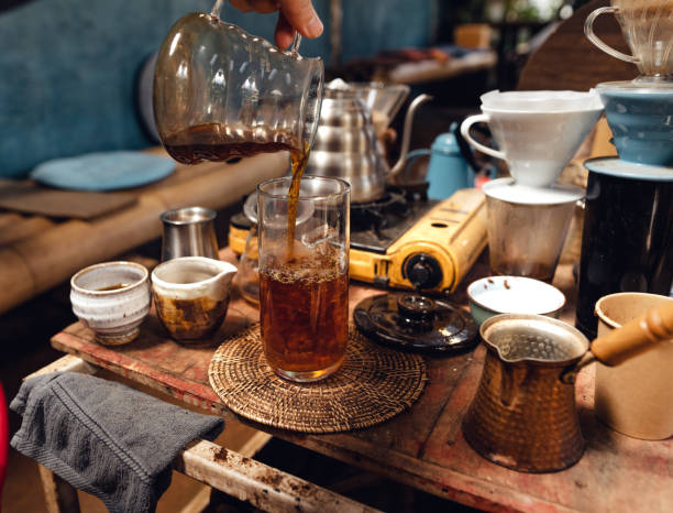 istock Man pouring hot water on ground coffee with paper filter to making a drip coffee 1465758665