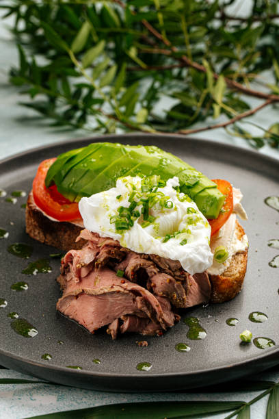 Avocado sandwich with roast beef and poached egg