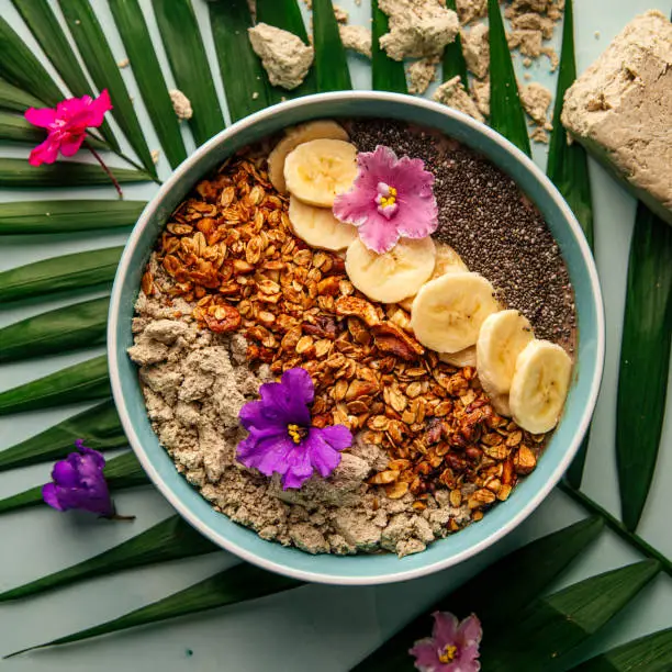 Photo of Smoothie bowl with halva bananas seeds and granola