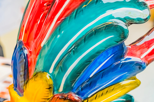 Close-up window display of coloured Venetian glass gifts in a shop window in Venice .