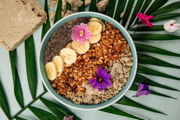 Photo of Smoothie bowl with halva bananas seeds and granola