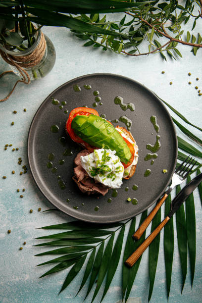 Avocado sandwich with roast beef and poached egg