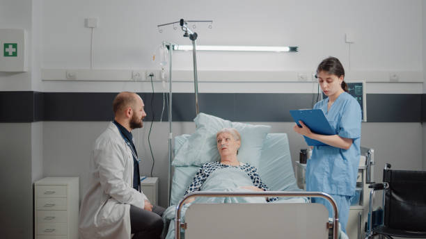istock Medical team doing consultation with old patient in bed 1465761443