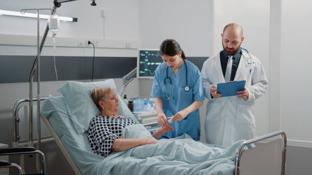 istock Medical team doing checkup visit for aged patient with disease 1465762363