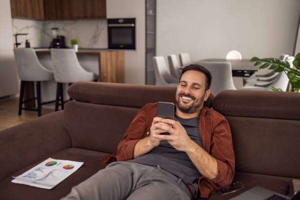 istock Smiling businessman working at home office 1465764147