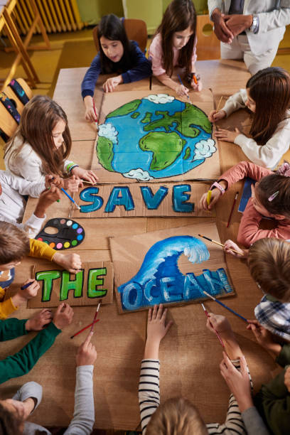 istock Above view of students drawing on art class at elementary school. 1465764191
