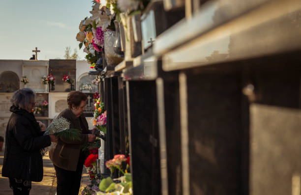 two women, mother and daughter mourning in cemetery - funeral family sadness depression imagens e fotografias de stock