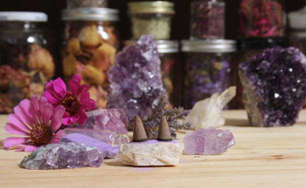 istock Amethyst Crystals With Flowers and Incense Cones on Meditation Table 1465768147