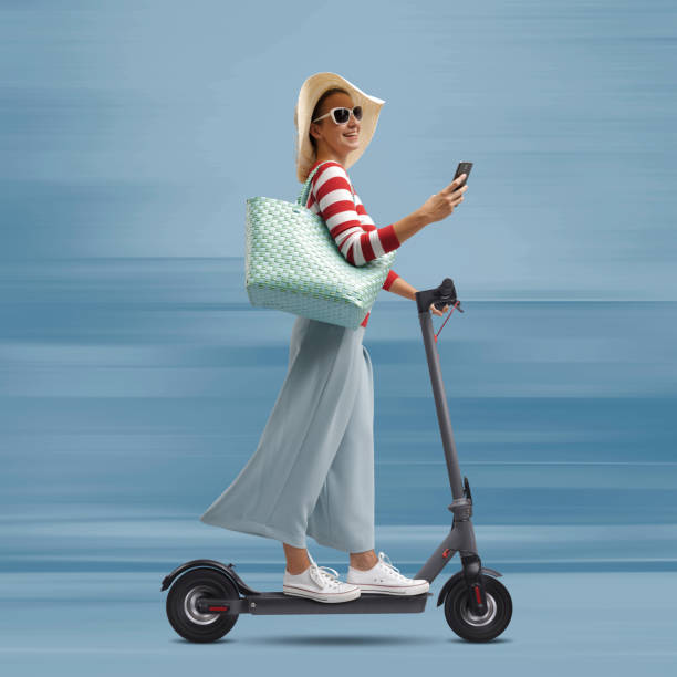 istock Woman riding a scooter and using her smartphone 1465773752
