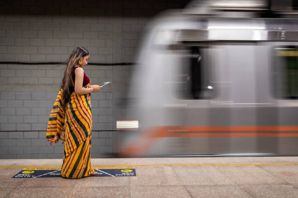 istock Indian girl using a digital tablet at metro station, India 1465777279