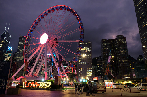 People by the The Hong Kong observation wheel by night, Central district.