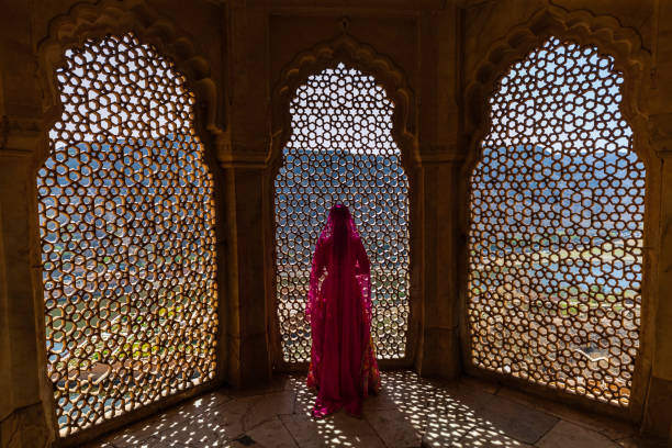 istock Young Indian woman looking through the window 1465781196