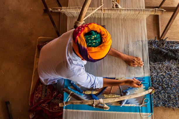 istock Indian man weaving textiles (durry) in Rajasthan 1465782508