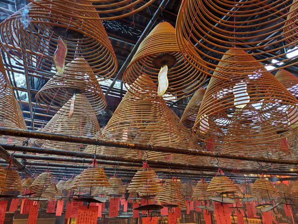 Hanging incense coils at Man Mo Temple, Hong Kong. It is the largest of the many Man Mo temples in Hong Kong and is located at Hollywood Road, in Sheung Wan. It was built in 1847. It is now a declared monument. \nHong Kong