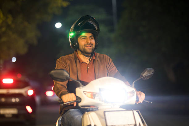 istock Happy man riding motorcycle with helmet at night 1465789111
