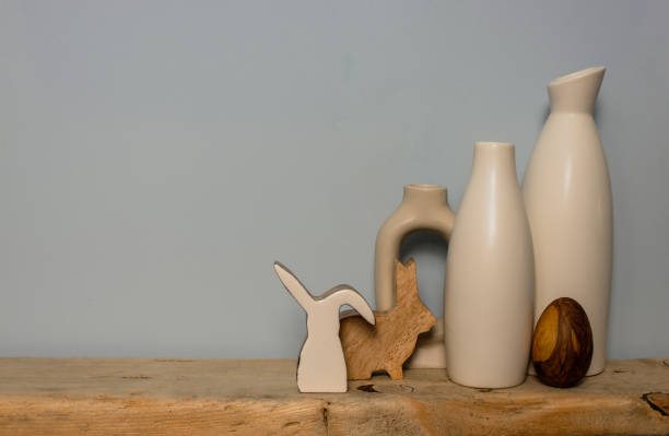 istock Rustic wooden decor white vases and an easter bunny figure on a wooden shelf. Copy space. 1465789455