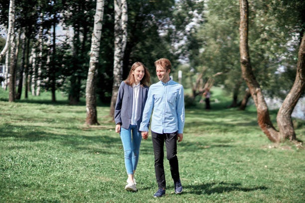 happy couple in love walking along a path in the park. love story.