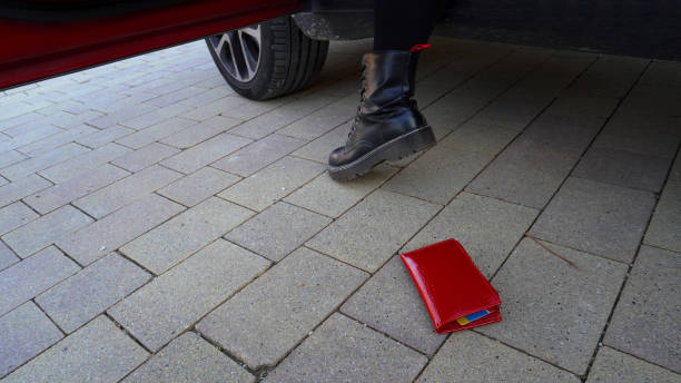 istock red wallet lost by a person getting into a car 1465792098