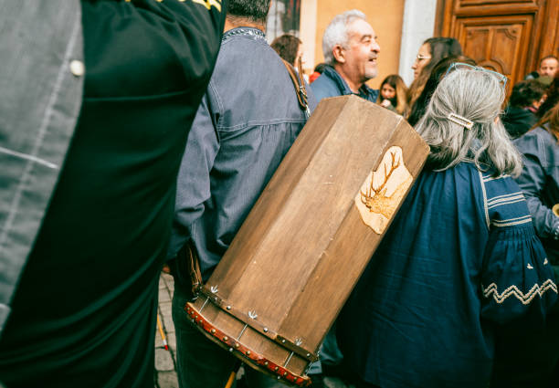 December 18th 2022, Madrid,Spain: Musicians in traditional clothing carrying a zambomba at Mayor Square in Madrid for Zambomba Festival during Christmas. \n\nIt is a celebration during Christmas which flamenco style carols are sung in the streets of different towns in Spain.The name comes from the typical instrument used at Christmas time, which accompanies popular canticles and Christmas carols since old times.It is a kind of improvised percussive instrument, which used to be made from a clay flowerpot or a paint tin. Over the pot, a piece of leather is stretched and a cane or a stick inserted through the skin. The up-and-down movement of the stick creates the characteristic droning sound of the Zambomba.
