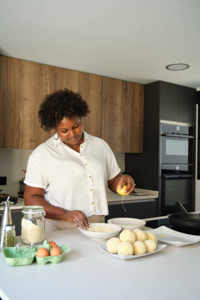 istock Young cuban woman breading mashed potatoes balls. 1465798414