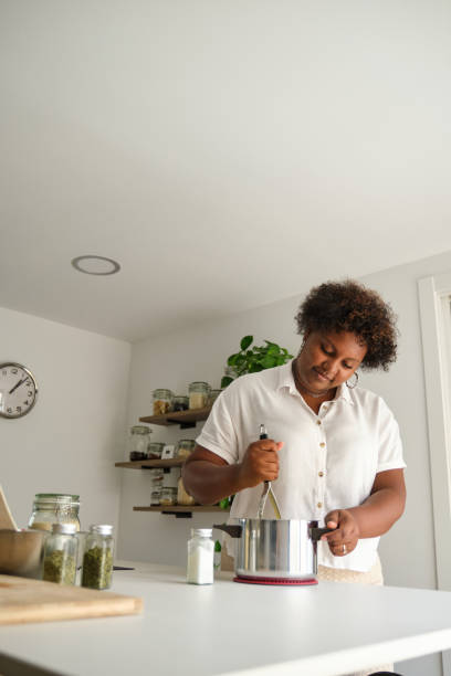istock Young cuban woman mashing potatoes. 1465798653