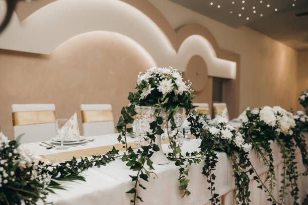 istock Beautiful white floral arrangement on a venue table 1465803334
