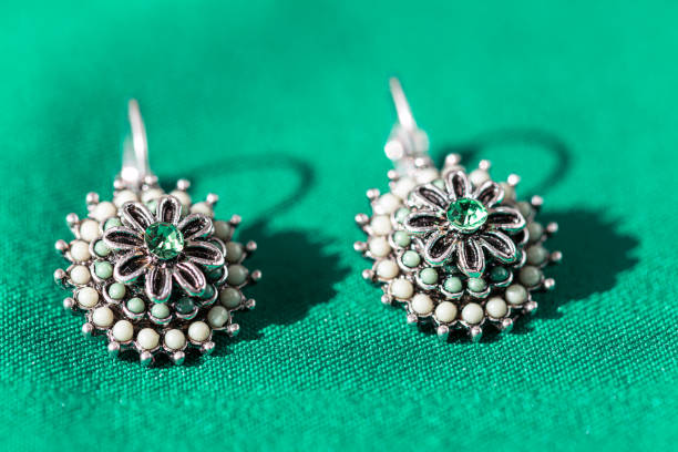 Earrings made in shape of flower . Jewelry made by silver and white stones