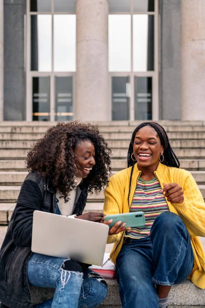 istock Cool Afro Girls Using Phone 1465805345