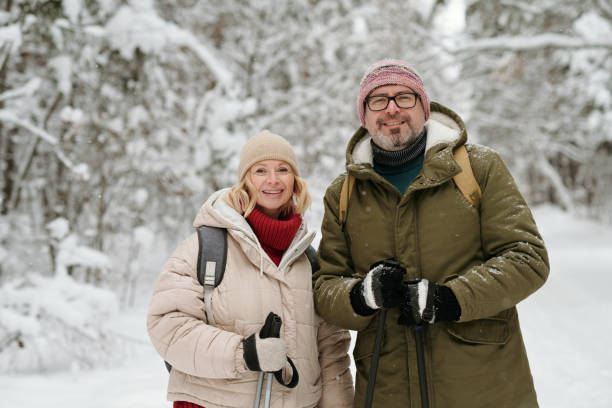 istock Cheerful senior couple with trekking sticks looking at camera 1465805965