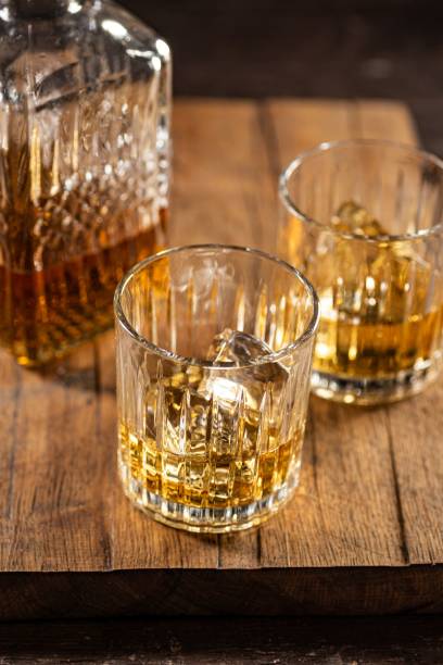 istock Whisky glasses with a bottle on a wooden board 1465806395