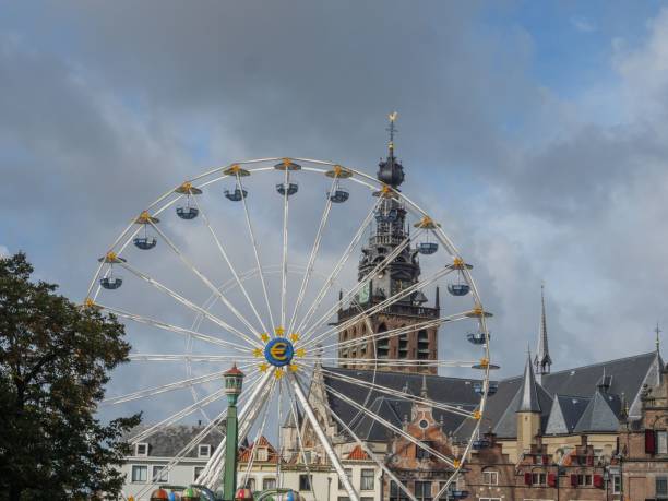 istock Old cathedral behind a Ferris wheel under cloudy sky in the Netherlands 1465806491