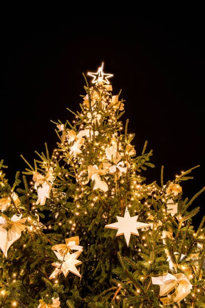 istock Vertical low angle shot of an illuminated decorated Christmas tree 1465809166