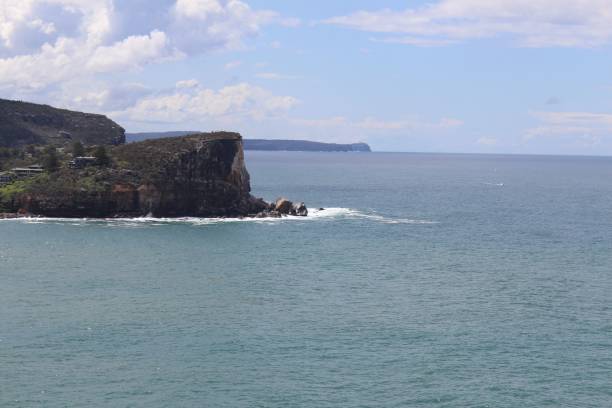 istock Rocky cliff with a sea view and blue cloudy sky 1465809172