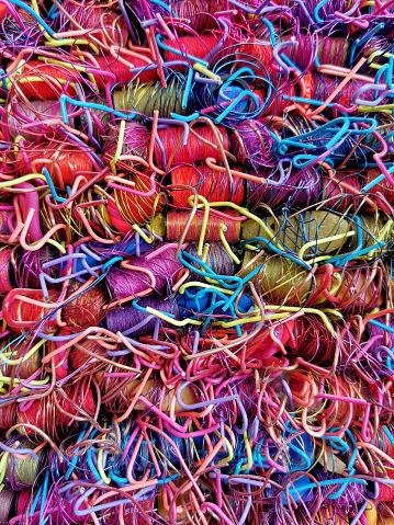 A vertical closeup shot of a heap of bright colorful string
