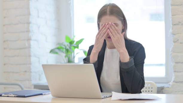 istock Young Businesswoman Upset while Working on Laptop and Documents 1465817134