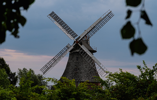 A stone windmill during a cloudy and dark day