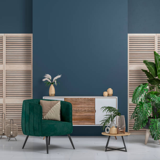 Cozy retro-chic interior with an art deco armchair, cabinet and potted plants, 50s- 60s decoration Cozy retro-chic interior with a green velvet armchair and a low white and hardwood cabinet in front of a Parisian blue/denim blue plaster wall background with copy space. A low coffee table with ceramic containers, vases on the white hardwood floor, birdcage lamps, and decoration (lush foliage: monstera, banana/palm tree, pillow) with 2 hardwood slat doors on each side. The 50s- 60s decoration, art deco style. A slight vintage effect was added. 3D rendered image. art deco vase stock pictures, royalty-free photos & images