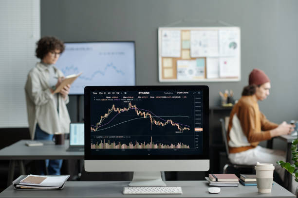 istock Computer monitor with graphic financial data on screen standing on desk 1465820431
