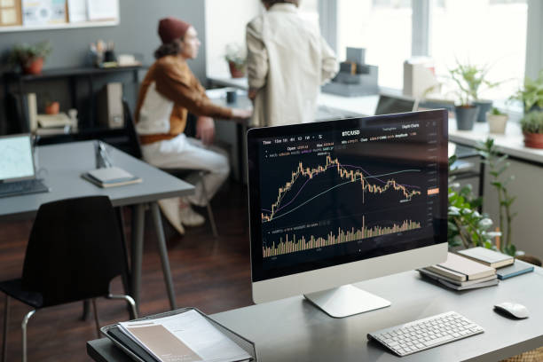 istock Workplace of financial analyst with graphic data on screen of computer 1465820490